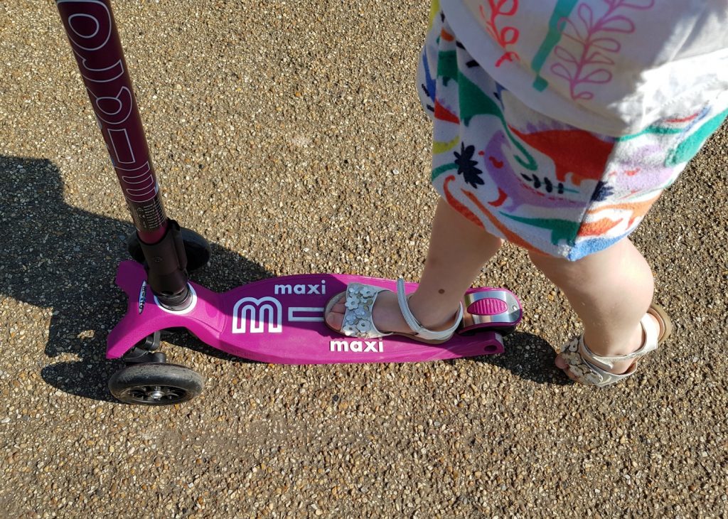 My daughter's sandal foot on her berry Micro Maxi Deluxe scooter