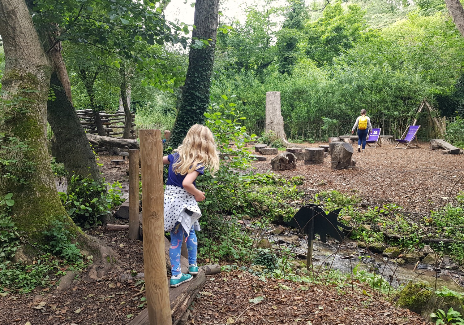 My daughter balances on one of the wooden beams in the natural play area at Ightham Mote, Kent