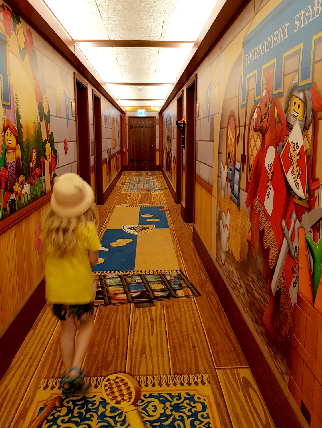 My daughter walks through the corridors of the Legoland Castle Hotel with its knights, princesses and wizards theme - my review of the Legoland Castle Hotel in Billund, Denmark