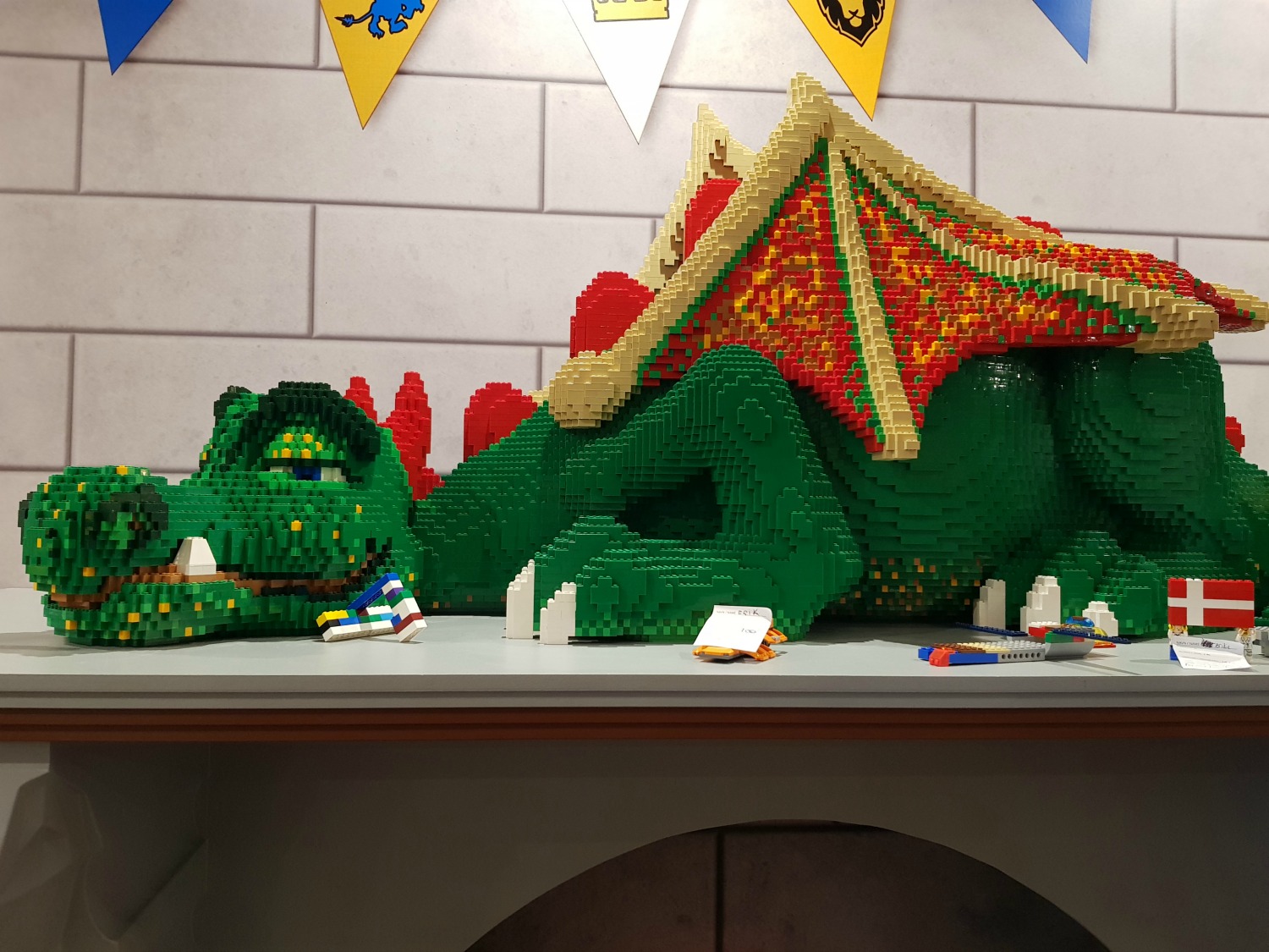 Lego dragon statue dozing on the fireplace in reception of the Legoland Castle Hotel - my Legoland Castle Hotel Billund review