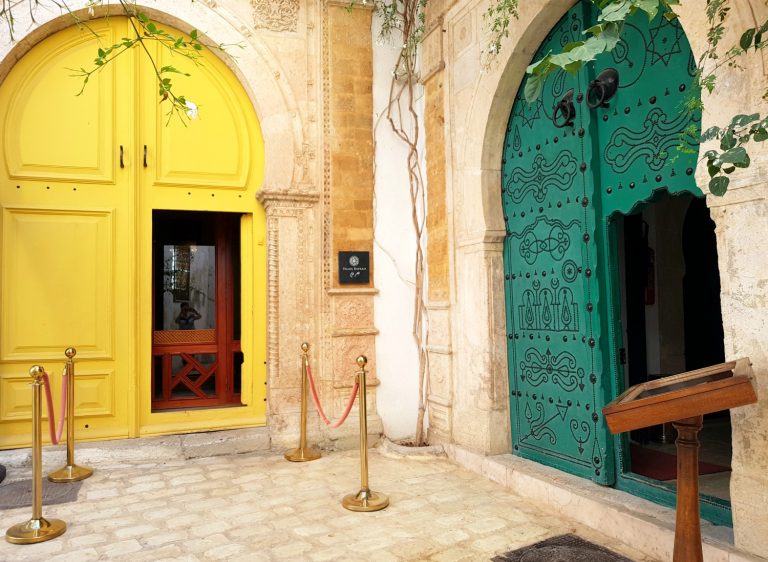 Bright yellow and green studded doorways at the entrance to Palais Bayram hotel in Tunis - my Palais Bayram review
