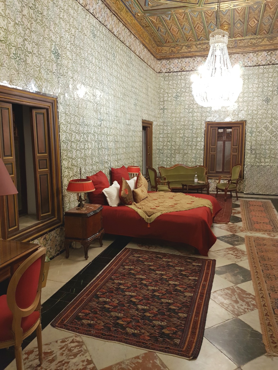 The tiled walls and grand red and gold decorations of the Sheikh Bayram grand historic suite at Palais Bayram