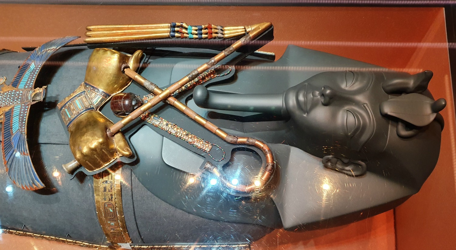 Model of Tutankhamun as he would have been buried with ritual regalia including flail and crook on display at the London Tutankhamun exhibition