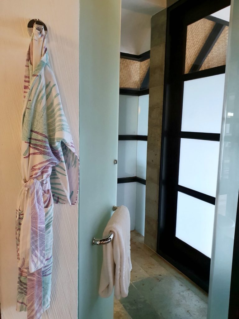 Child robe hanging up by the shower in the bathroom of our water villa in the Maldives at Kuda Huraa resort