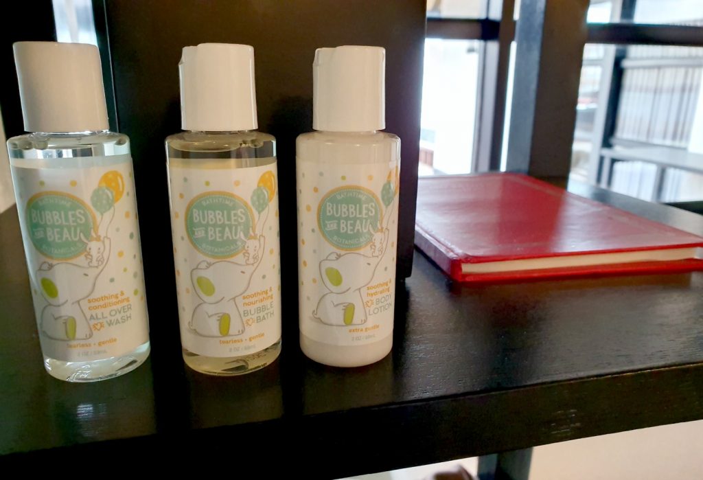 Children's toiletries and red bound copy of Ibn Battuta's memoire of his travels in the Maldives in the bathroom of our water villa at Four Seasons Kuda Huraa resort