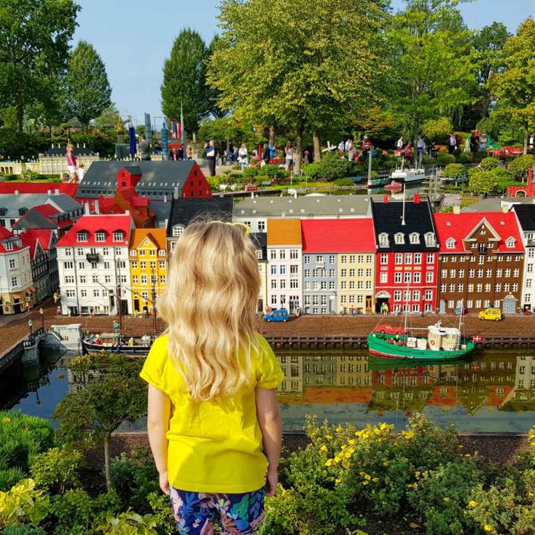 My daughter looking at some of the Lego houses in Miniand at Legoland Billund - but beyond the bricks, here are some of the best things to do near Legoland Billund with kids