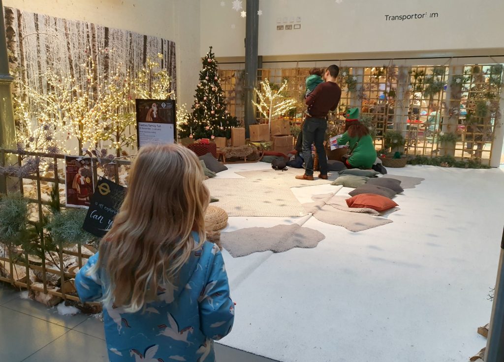 My daughter looks at the sparkly snowy effects in the grotto - one of the London Transport Museum Christmas activities on offer