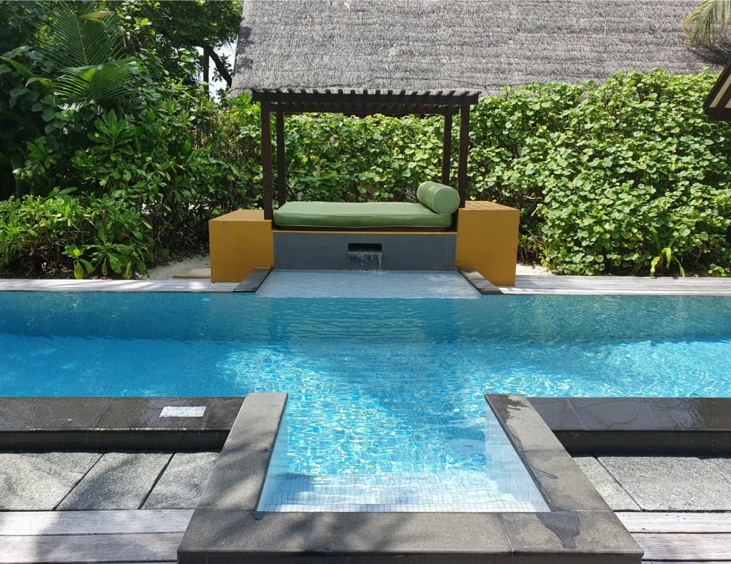 Day bed opposite the steps of the pool at our beach villa at Landaa Giraavaru resort in the Maldives