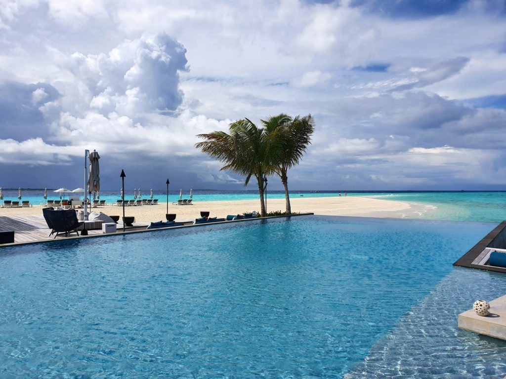 Rippling water of the pool near Blu restaurant at Landaa Giraavaru resort in the Maldives, lookingonly the beach and Indian Ocean beyond