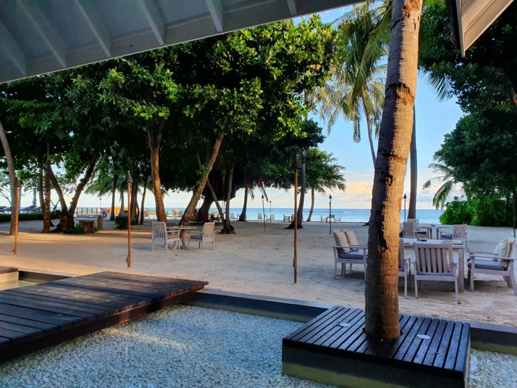 View from Cafe Landaa to the tables of Fuego Grill on the beach at Landaa Giraavaru resort in the Maldives