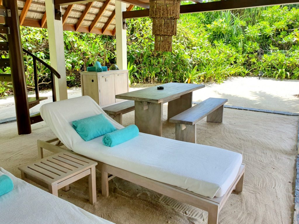 Loungers by the pool at our beach villa, at Landaa Giraavaru resort in the Maldives