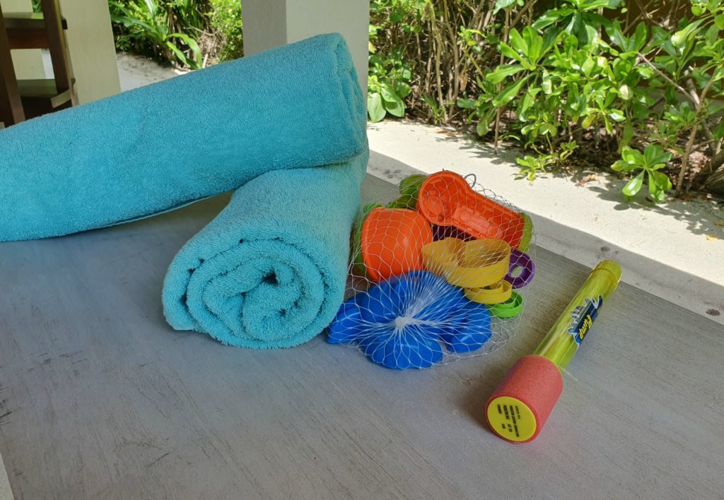 Towels and pool toys on the loungers by the pool at our beach villa, at Landaa Giraavaru resort in the Maldives