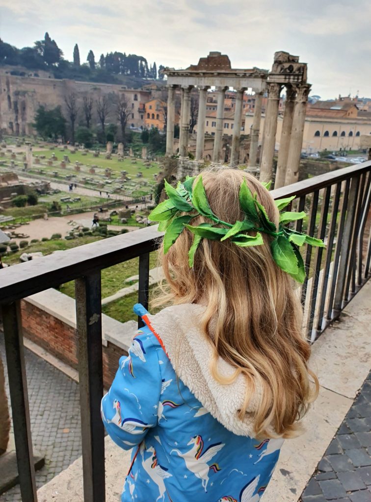 My daughter in a fake laurel wreath looks out over the ancient Roman forum - one of the lovely child-friendly touches we discovered as part of my Tapsy Tour review