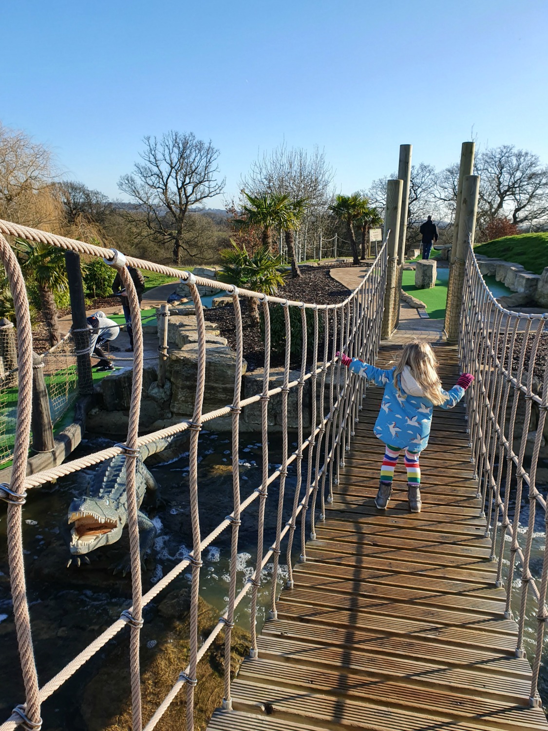 My daughter on the wobbly bridge in the Congo course at Lost Jungle London - visiting Lost Jungle adventure golf, Europe's biggest adventure golf course