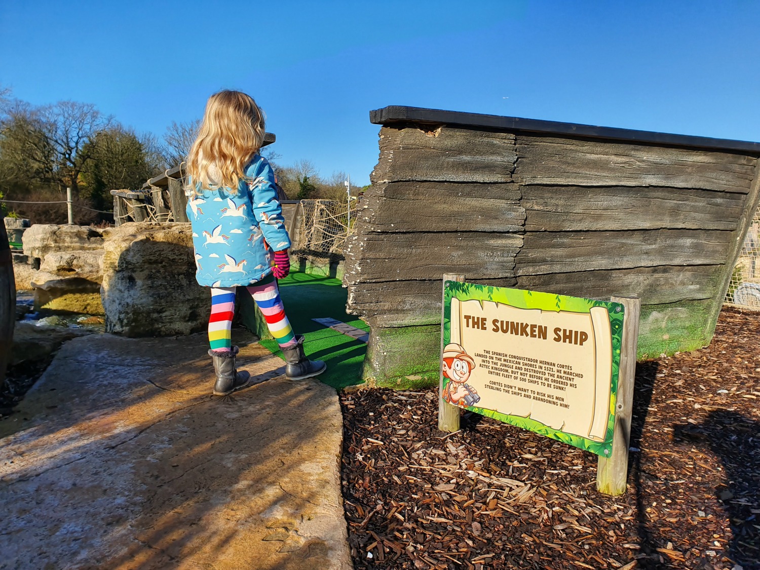 My daughter by the entrance to the sunken ship at Lost Jungle London - visiting Lost Jungle adventure golf, Europe's biggest adventure golf course