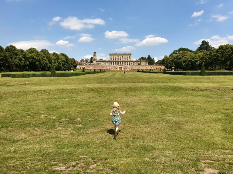 My daughter runs in the parterre gardens towards Cliveden house in the distance - visiting Cliveden after lockdown, now the National Trust has reopened