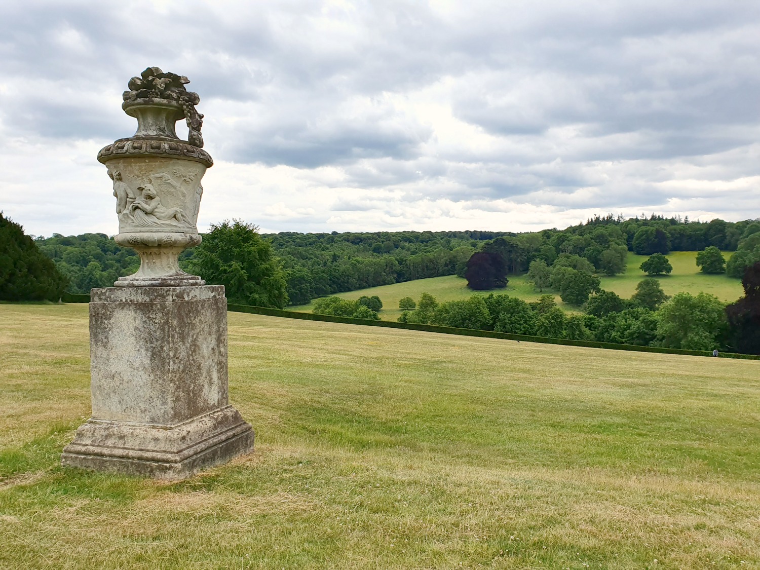 View across the deserted lawns of Polesden Lacey after lockdown, with stone urn in view - one of the National Trust reopened sites
