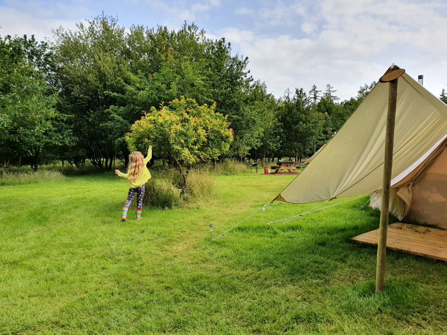 My daughter running around the campsite at Amber's Bell Tent Camping at Hopton Court in Shropshire