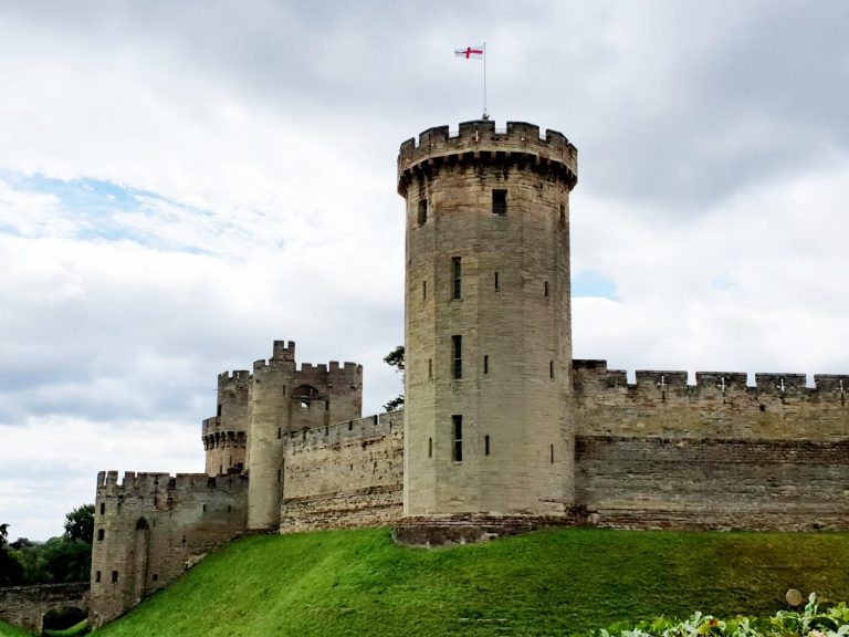A view of the exterior towers of the reopened Warwick Castle on a grey July day - Visiting Warwick Castle after lockdown with kids