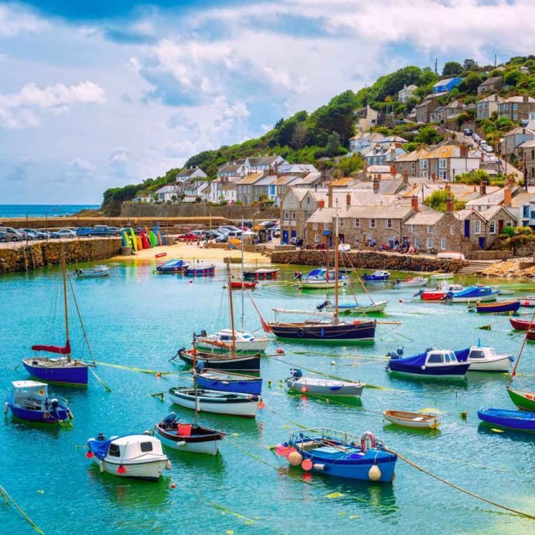 View of boats in the harbour at Mousehole village in Cornwall - my ultimate guide to Cornwall with kids