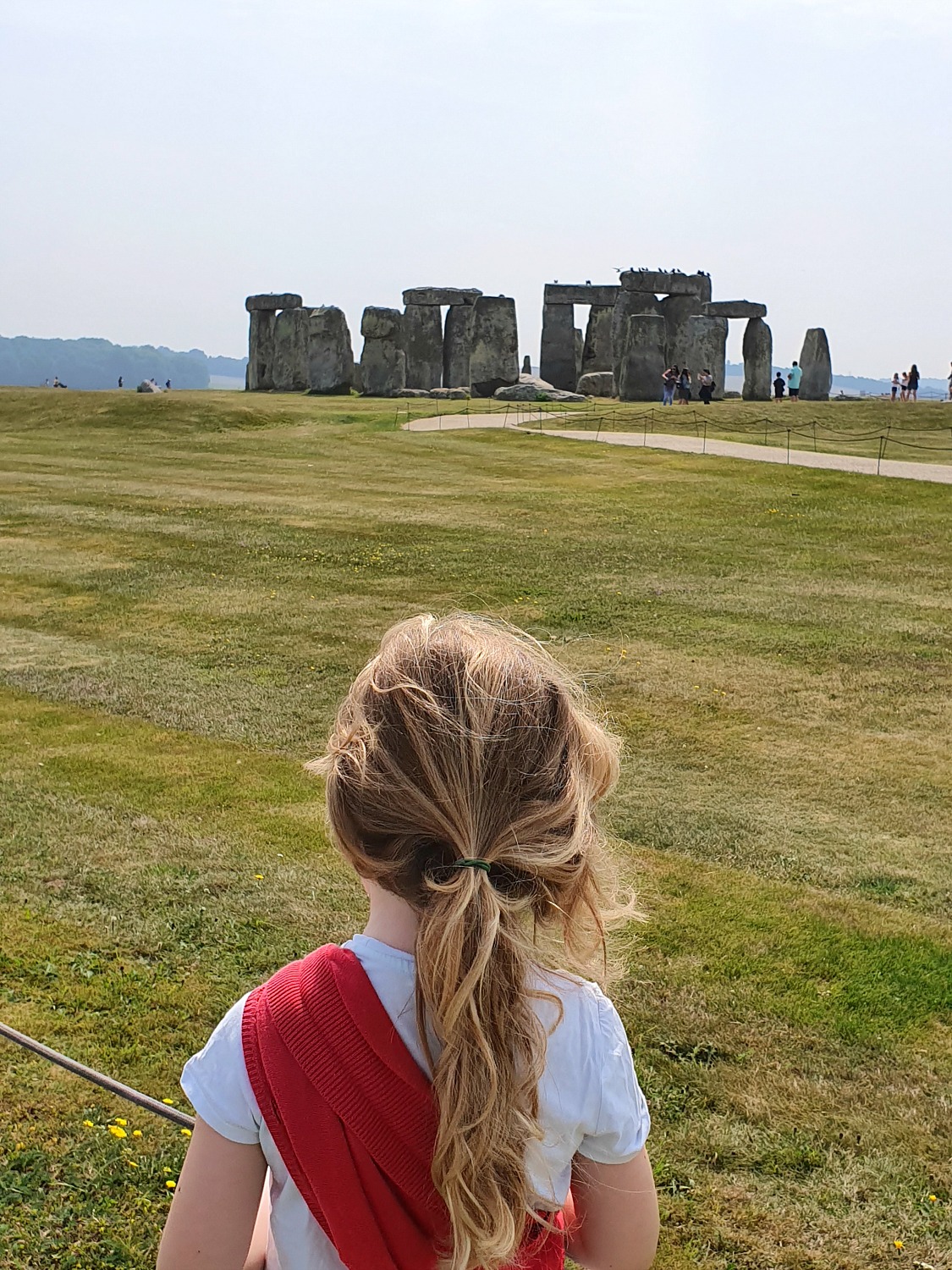 My daughter looks up towards Stonehenge on our visit after lockdown
