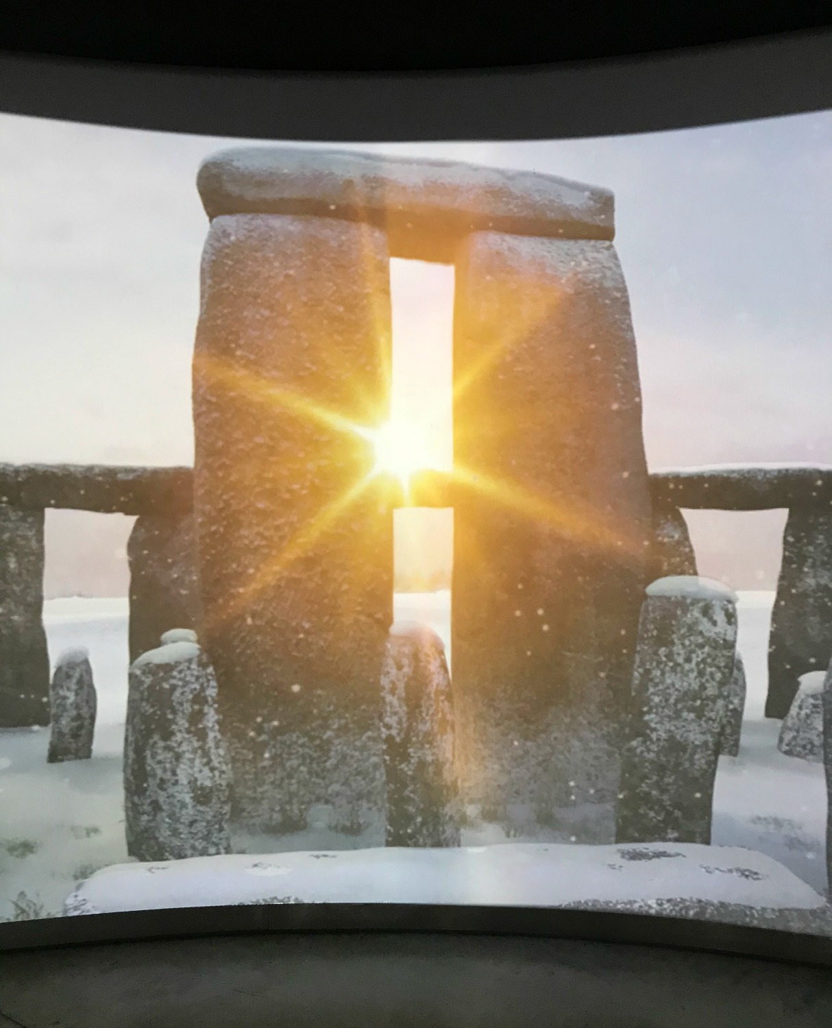 Sun shining through the stones at the winter solstice, part of the video on display as you enter the Stonehenge visitor centre