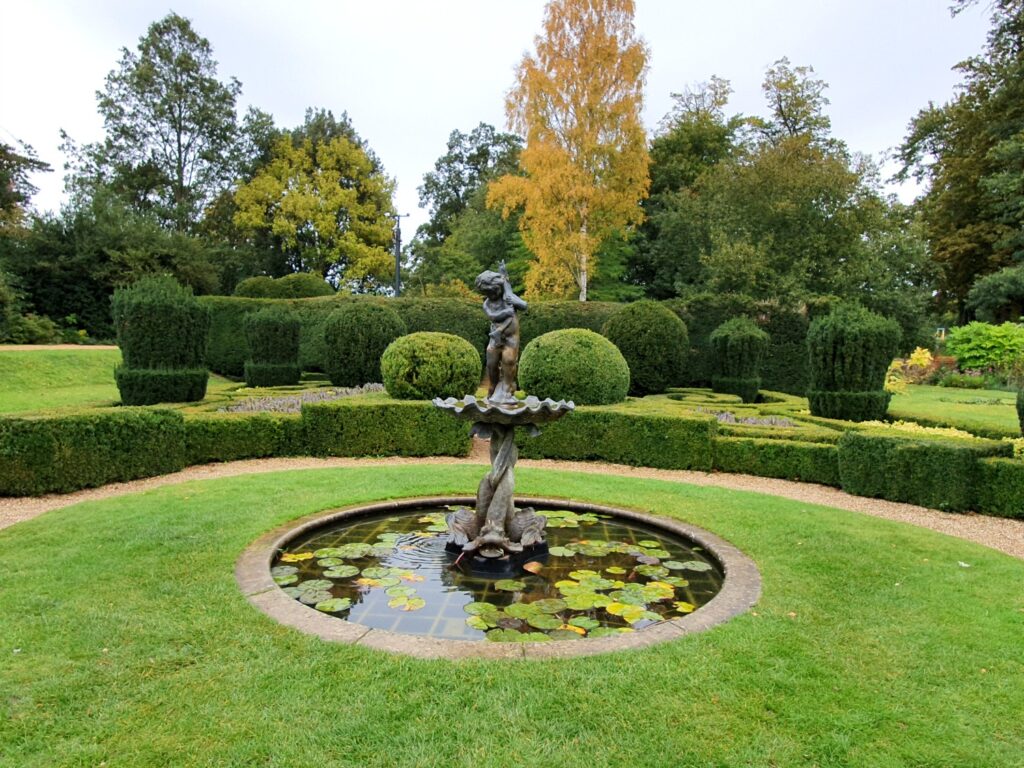 Statue in a pool at Bridge End Gardens in Saffron Walden, a great place to get outdoors during a weekend in Essex with kids