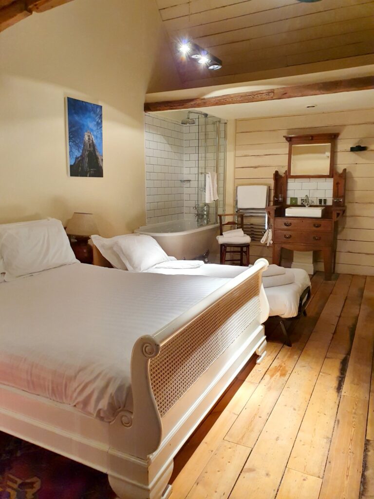 View of our bedroom at the Cross Keys in Saffron Walden, with double bed, my daughter's Z bed and claw foot bath in the corner