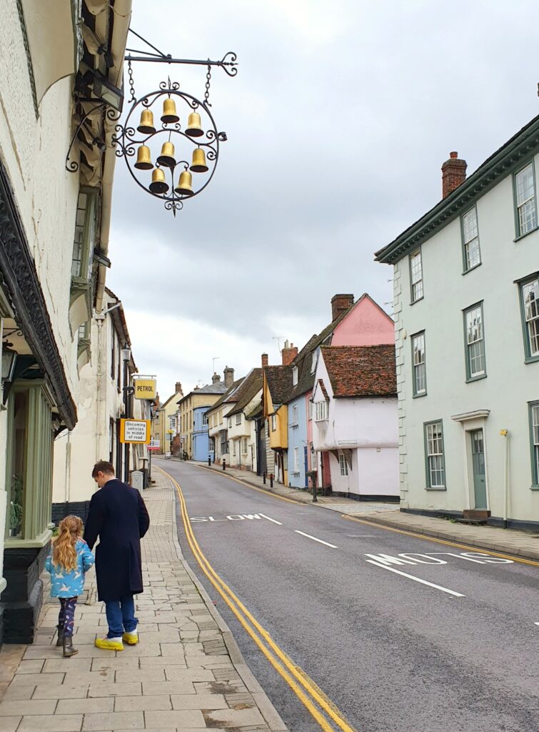 My husband and daughter by the sign for the Eight Bells in Saffron Walden during a weekend in Essex with kids