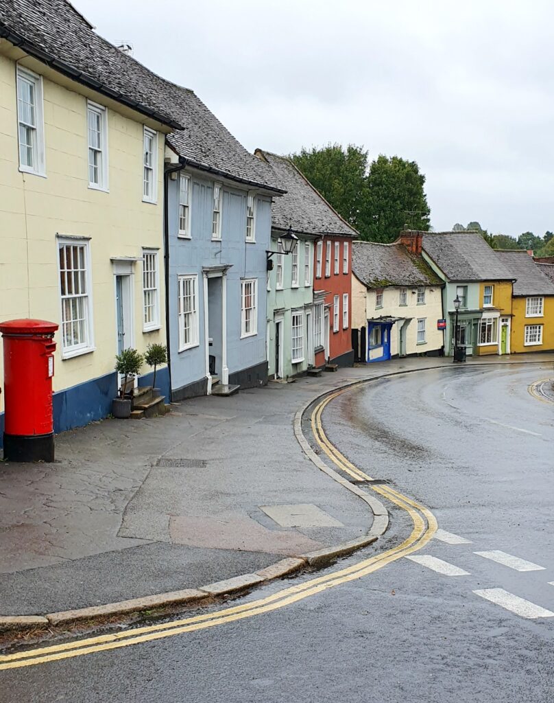 View of the colourful houses lining the main street of the historic village of Thaxted in Essex