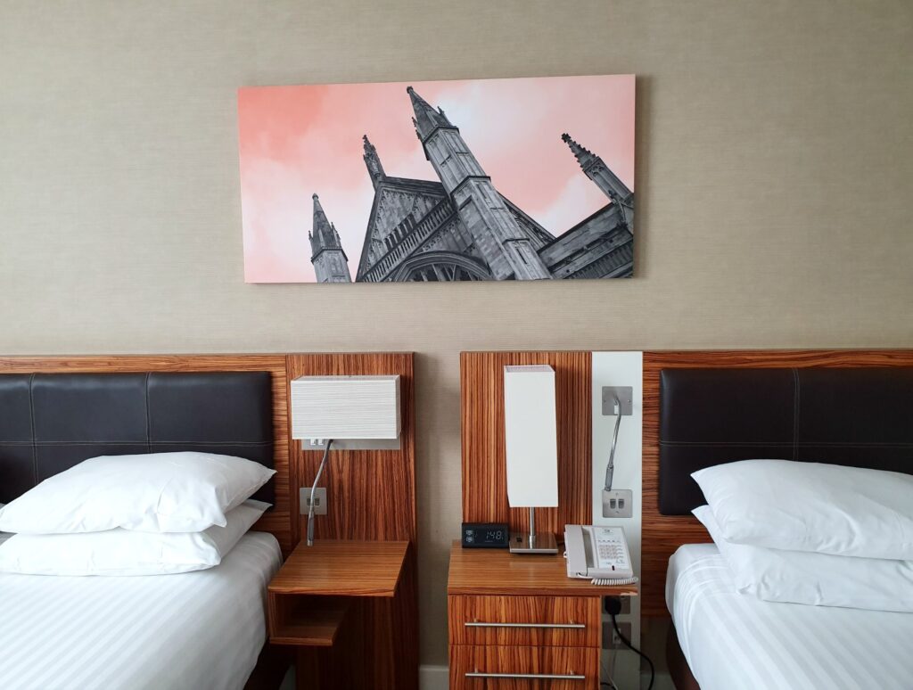 View of the Winchester cathedral artwork above the double beds in our room at Holiday Inn Winchester - one of the best places to stay in Winchester with kids