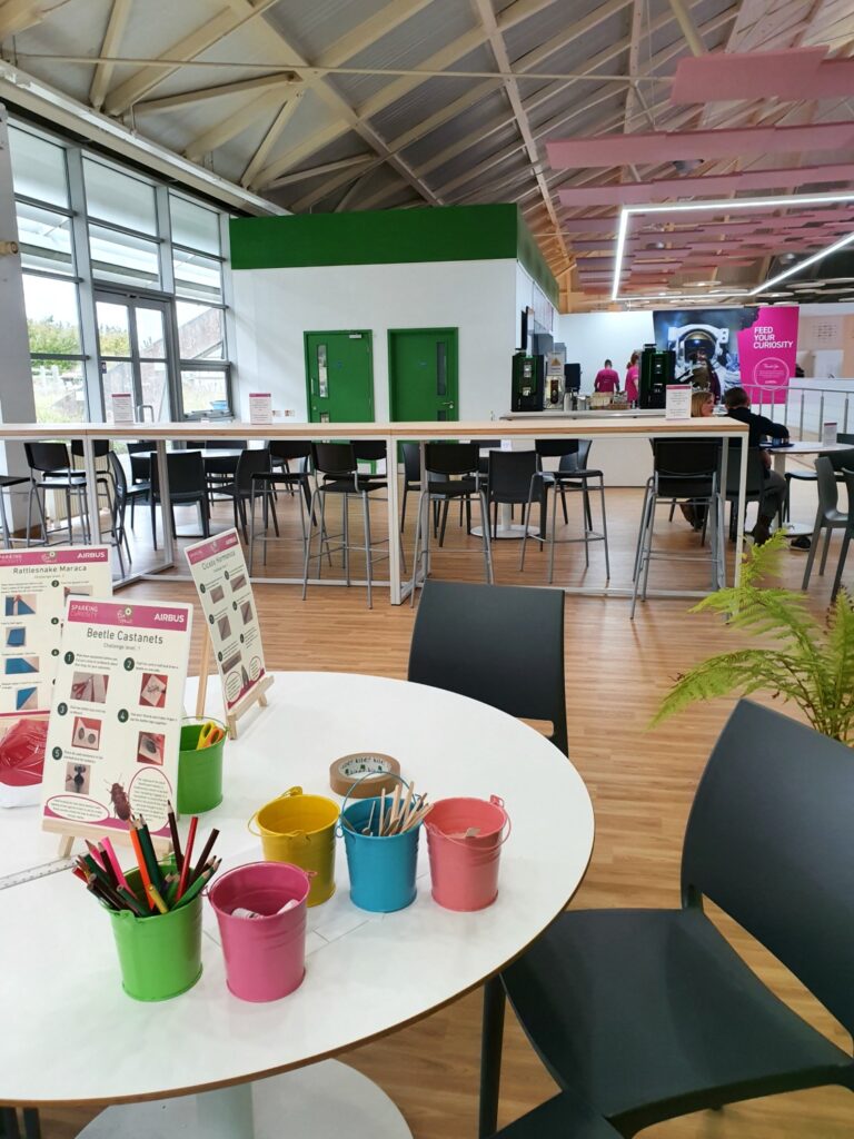 Craft table at Winchester Science Centre in Hampshire with the cafe in the background - my review