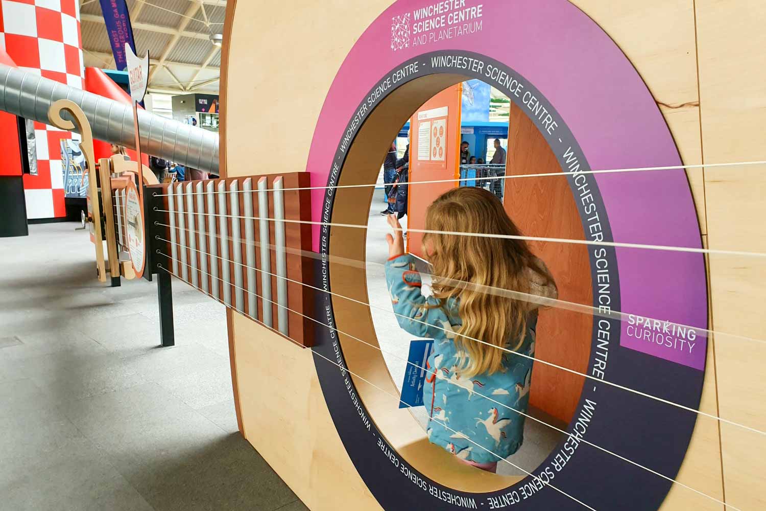 My daughter inside the giant guitar at Winchester Science Centre as part of the displays on sound - my Winchester Science Centre review