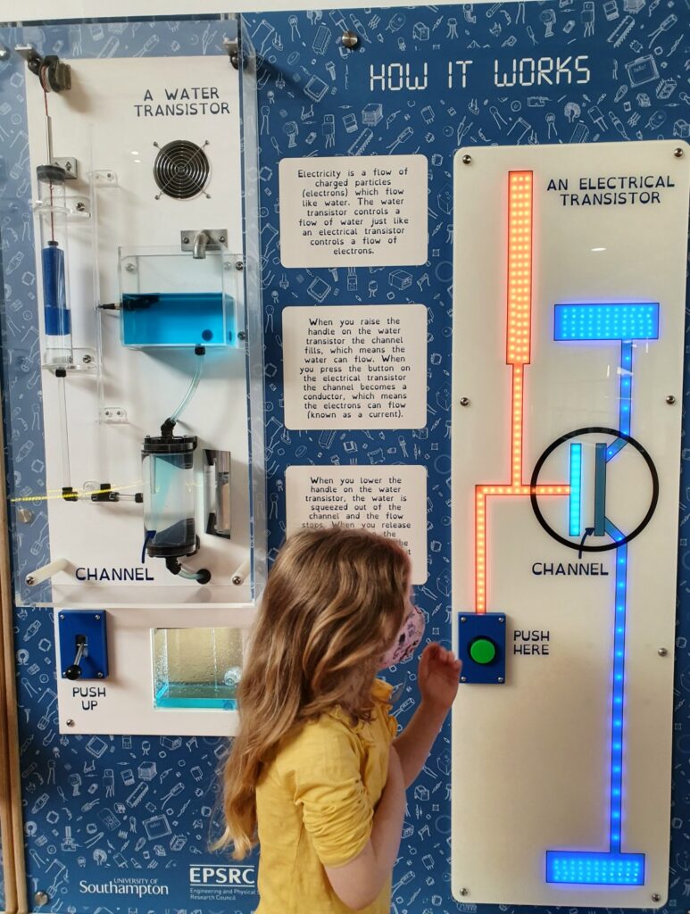 My daughter with a lit-up display illustrating transistors at the Winchester Science Centre