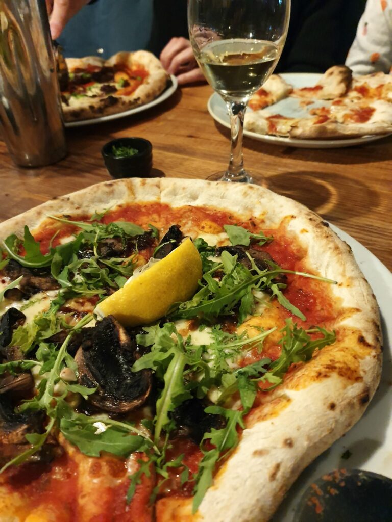 Mushroom and caramelised onion pizza with a slice of lemon on at Three Joes Winchester - one of my favourite places to eat in Winchester with kids