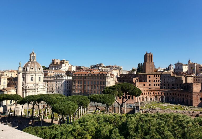 View across Trajan's market and column to the buildings and domes of Rome, Italy - experience more with a virtual tour of Rome