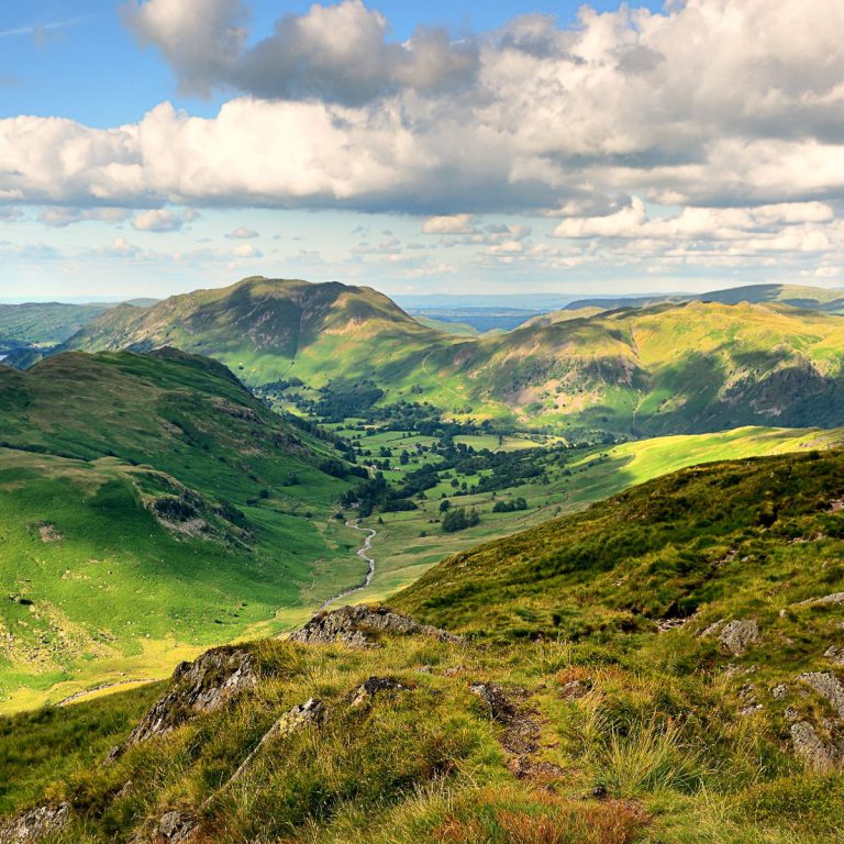View out to the hills of Dovedale with blue sky and clouds behind - my top things to do in the Peak District with kids, including ideas for a rainy day in the Peak District