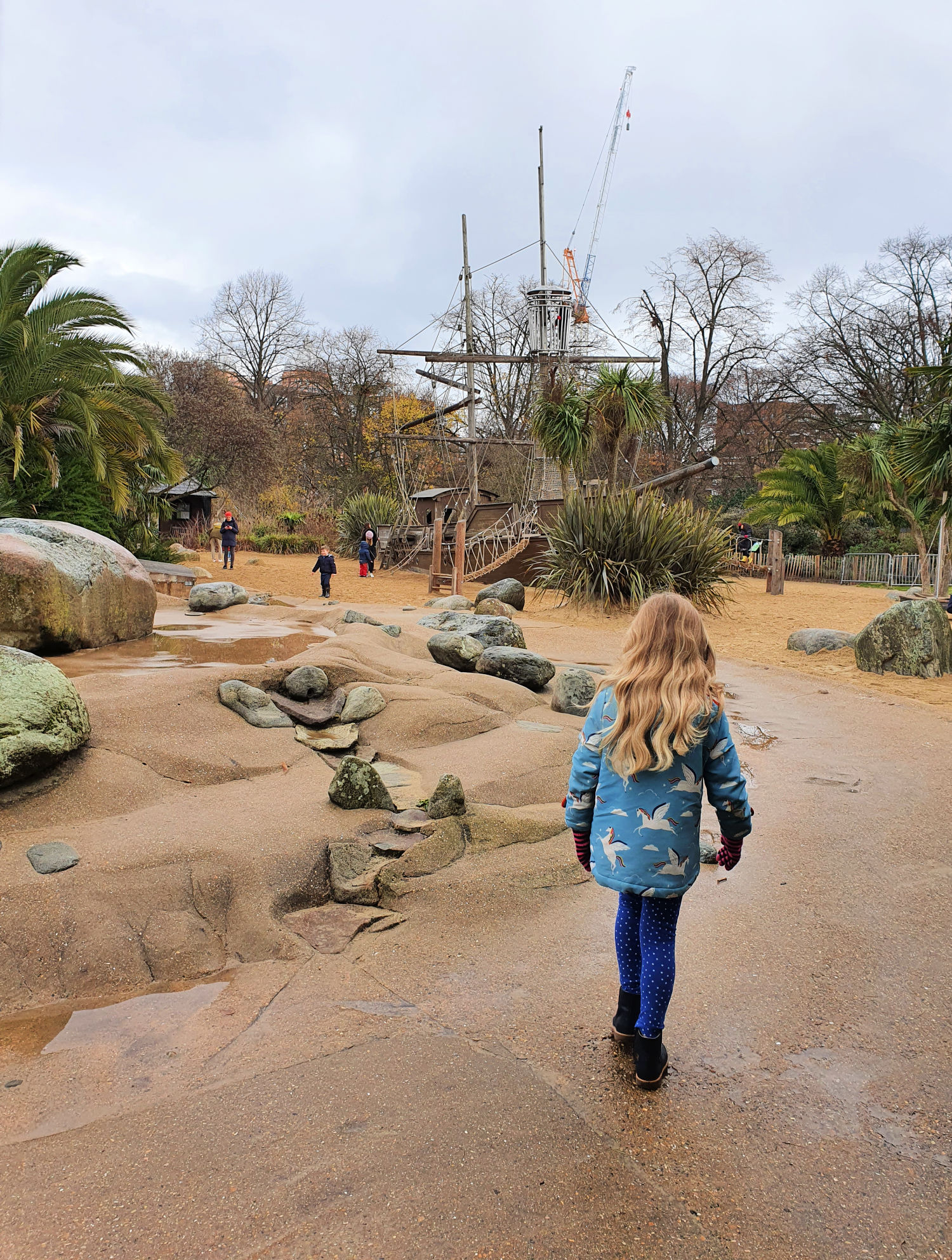 My daughter walks towards the pirate ship in the Diana Memorial Playground in Kensington Gardens, before our visit to Kensington Palace