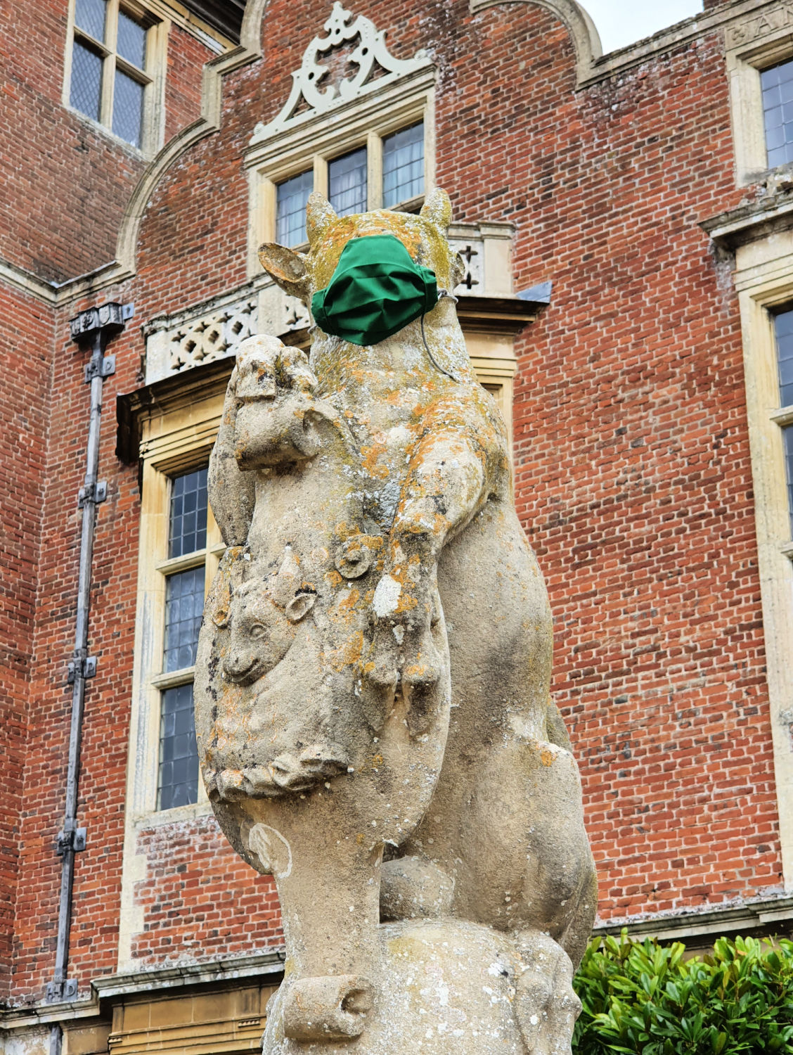 Bull statue at Blickling Hall wearing a face mask - one of the quirky touches during a family day out at Blickling Hall with kids