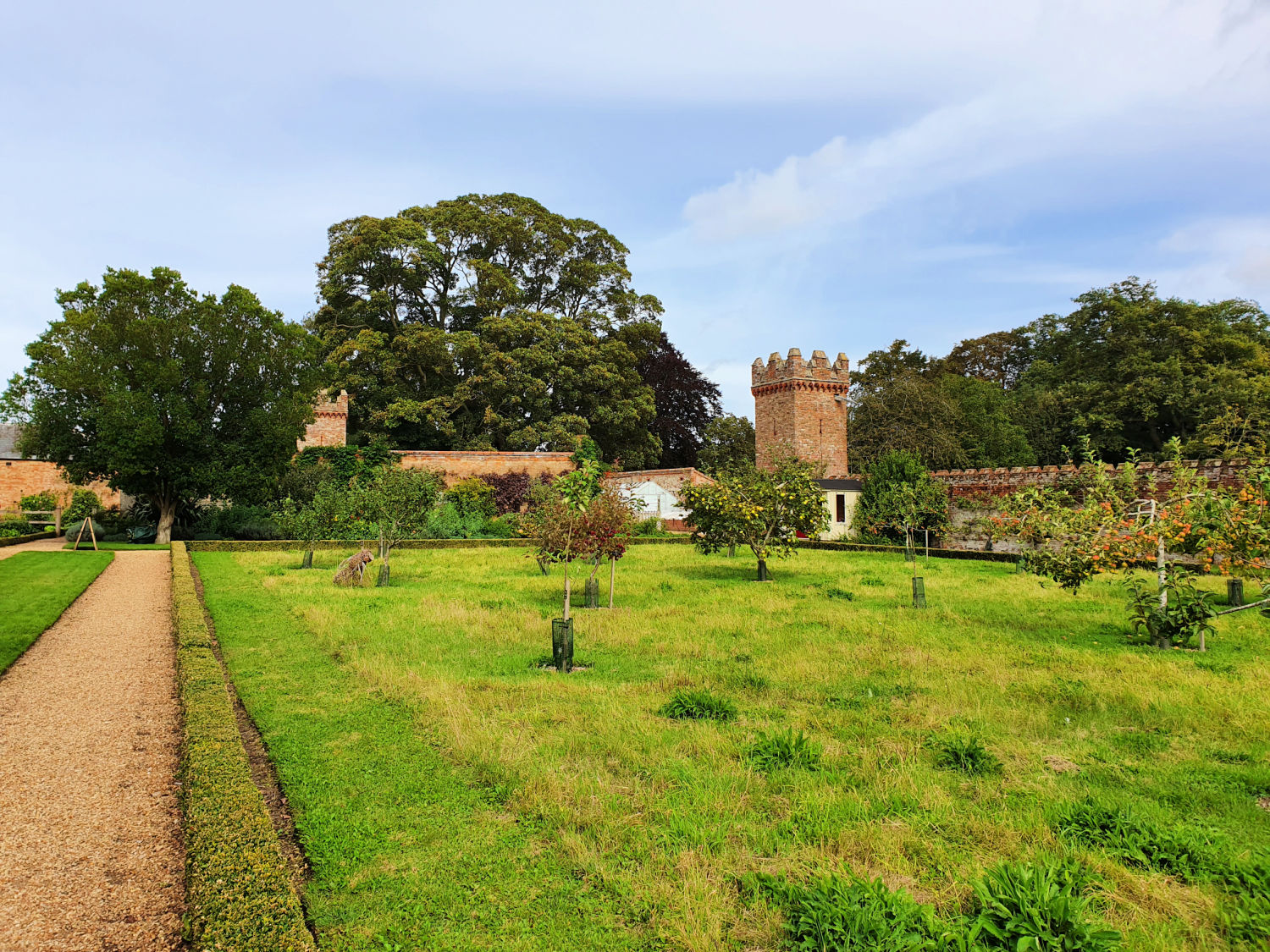 View of buildings across the gardens at Oxburgh Hall in Norfolk - a day out at Oxburgh Hall with kids