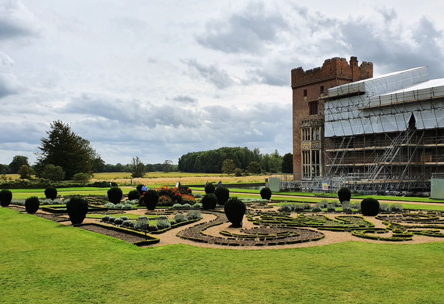 View across the parterre to Oxburgh Hall, partly covered in scaffolding - a day out at Oxburgh Hall with kids