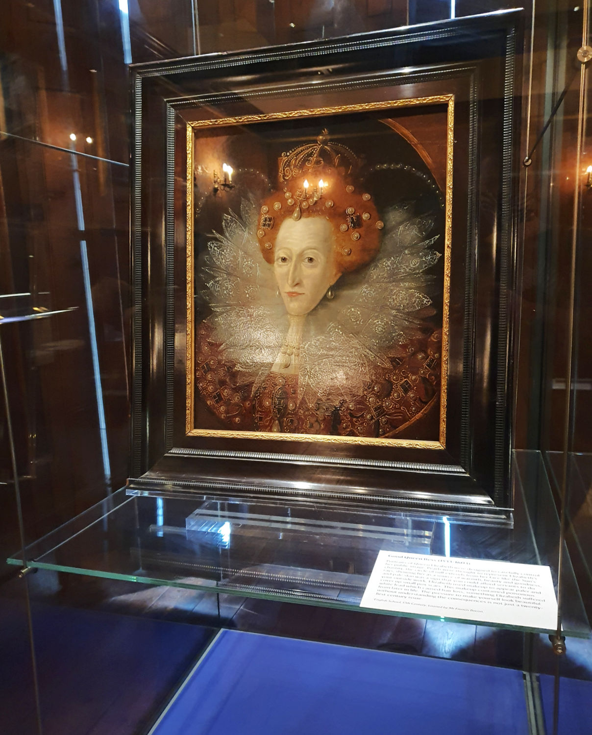 Portrait of Queen Elizabeth in a glass case, one of several royal items on display at Oxburgh Hall in Norfolk
