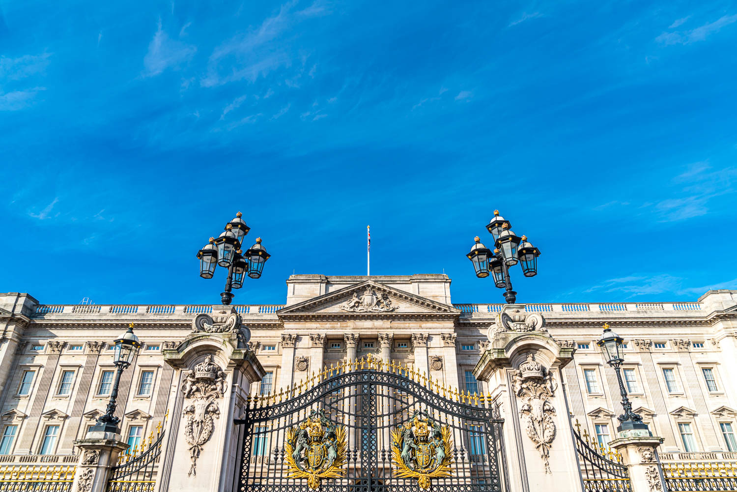 Gilded gates and front view of Buckingham Palace - the best of the many royal places in London to see with kids