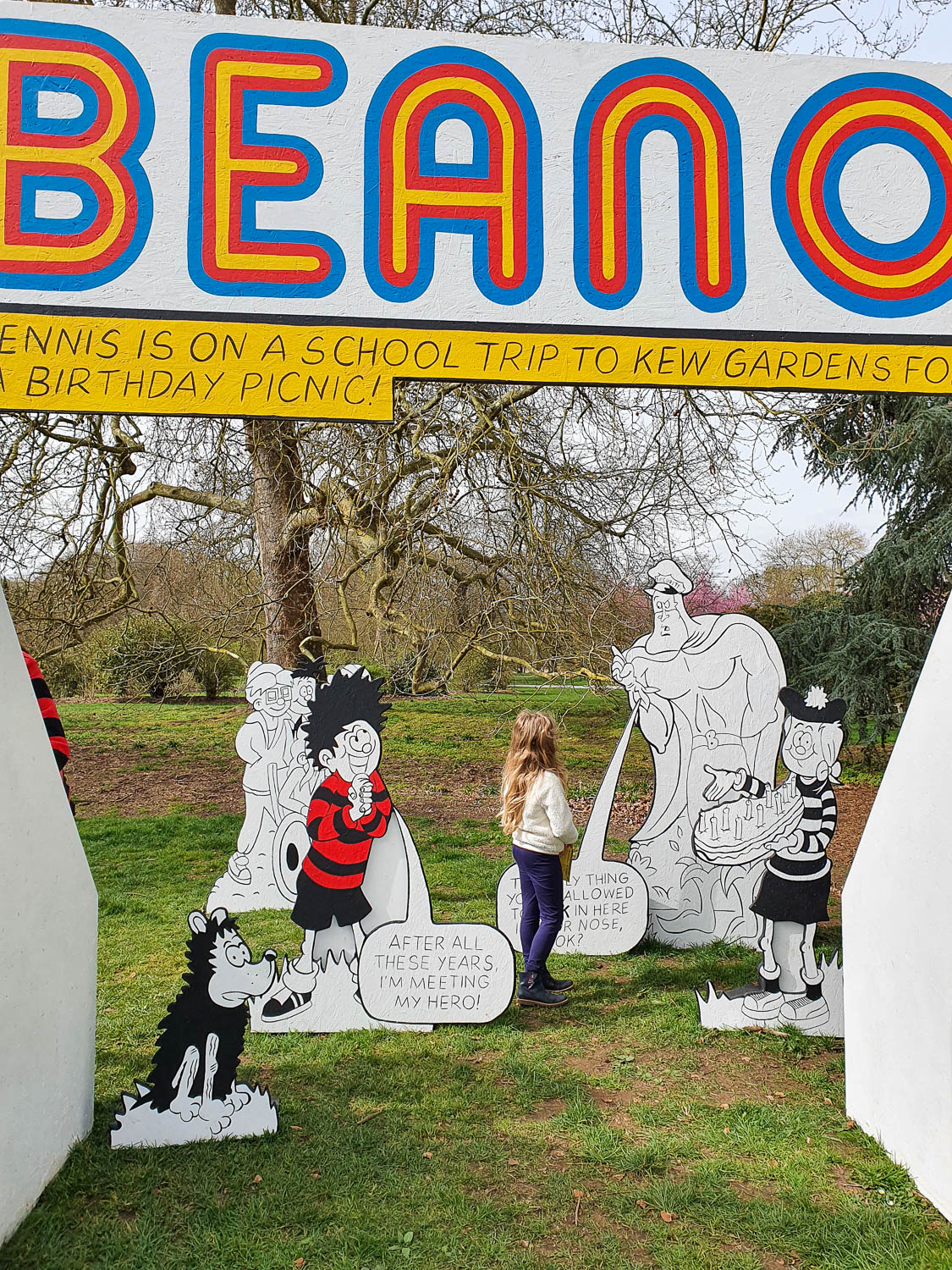 My daughter with Beano characters including Bananaman and Dennis the Menace as part of the kids trail for Easter at Kew Gardens