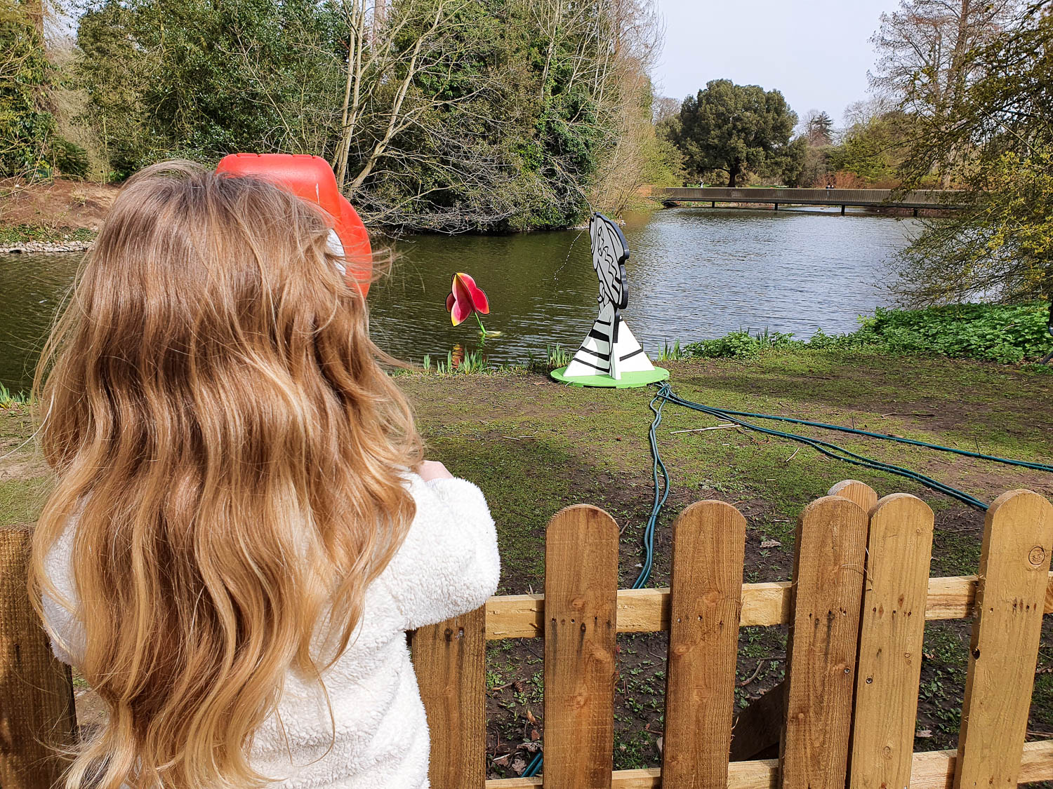 My daughter tries to fire water at an orchid in the lake as part of the kids trail for Easter at Kew Gardens