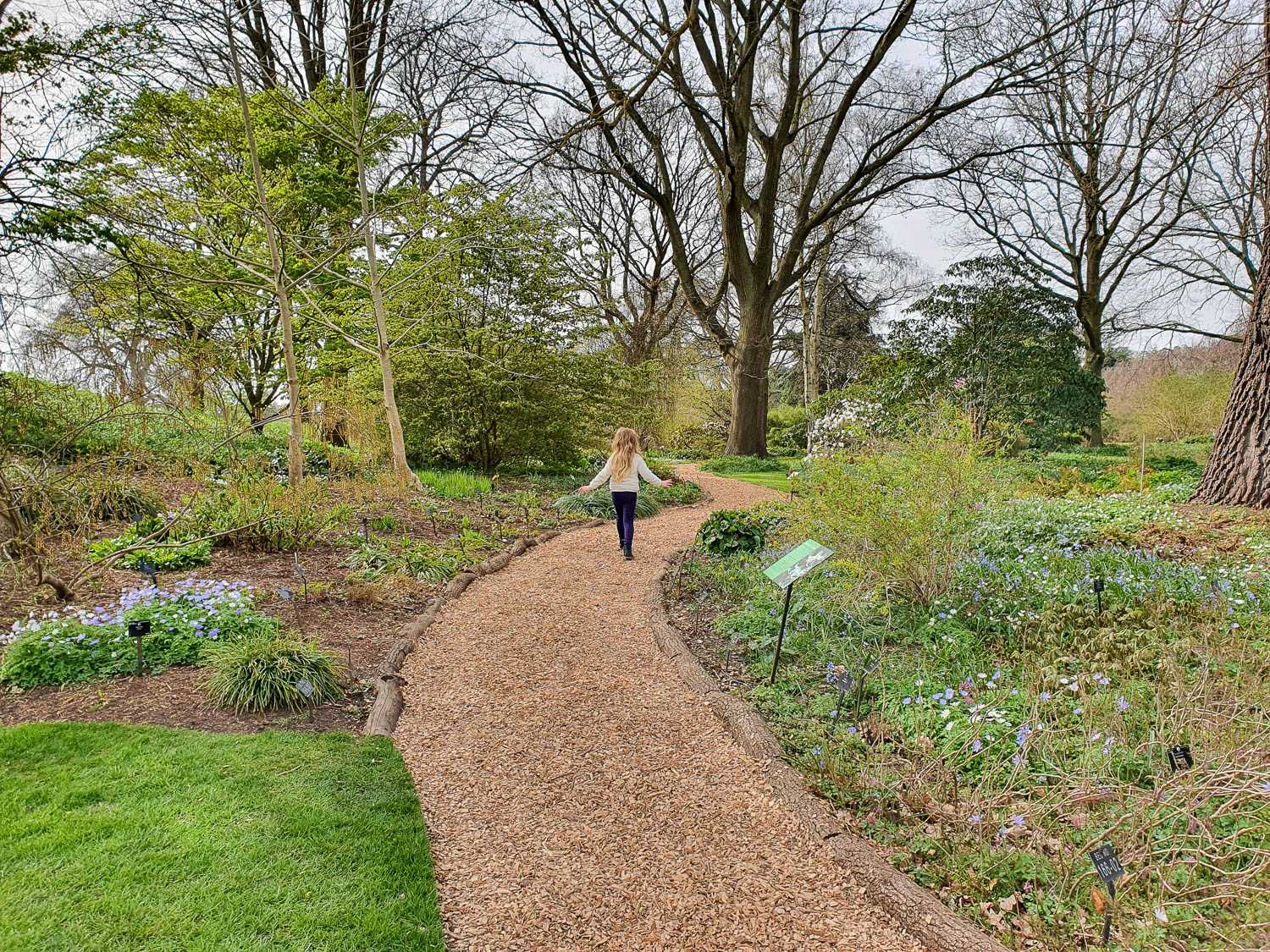 My daughter walks along a path through the rock garden during a visit to Kew Gardens at Easter
