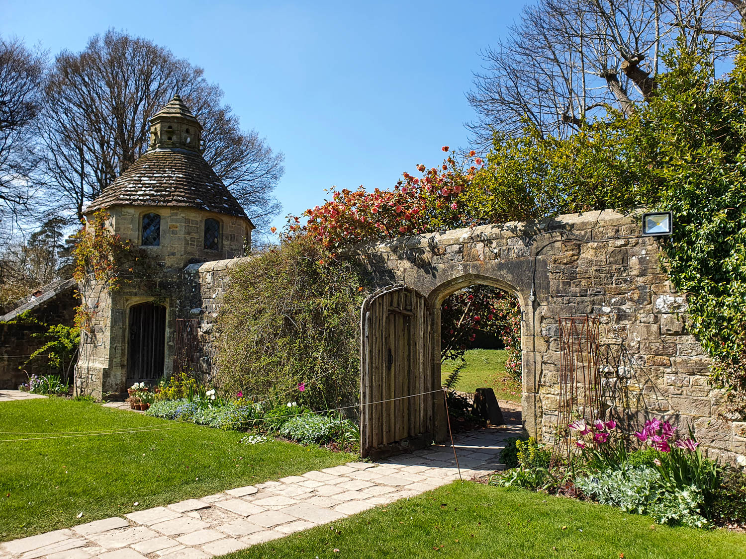 View of the wall in the garden by the house at Nymans leading into further gardens - visiting Nymans with kids on a day out in Sussex