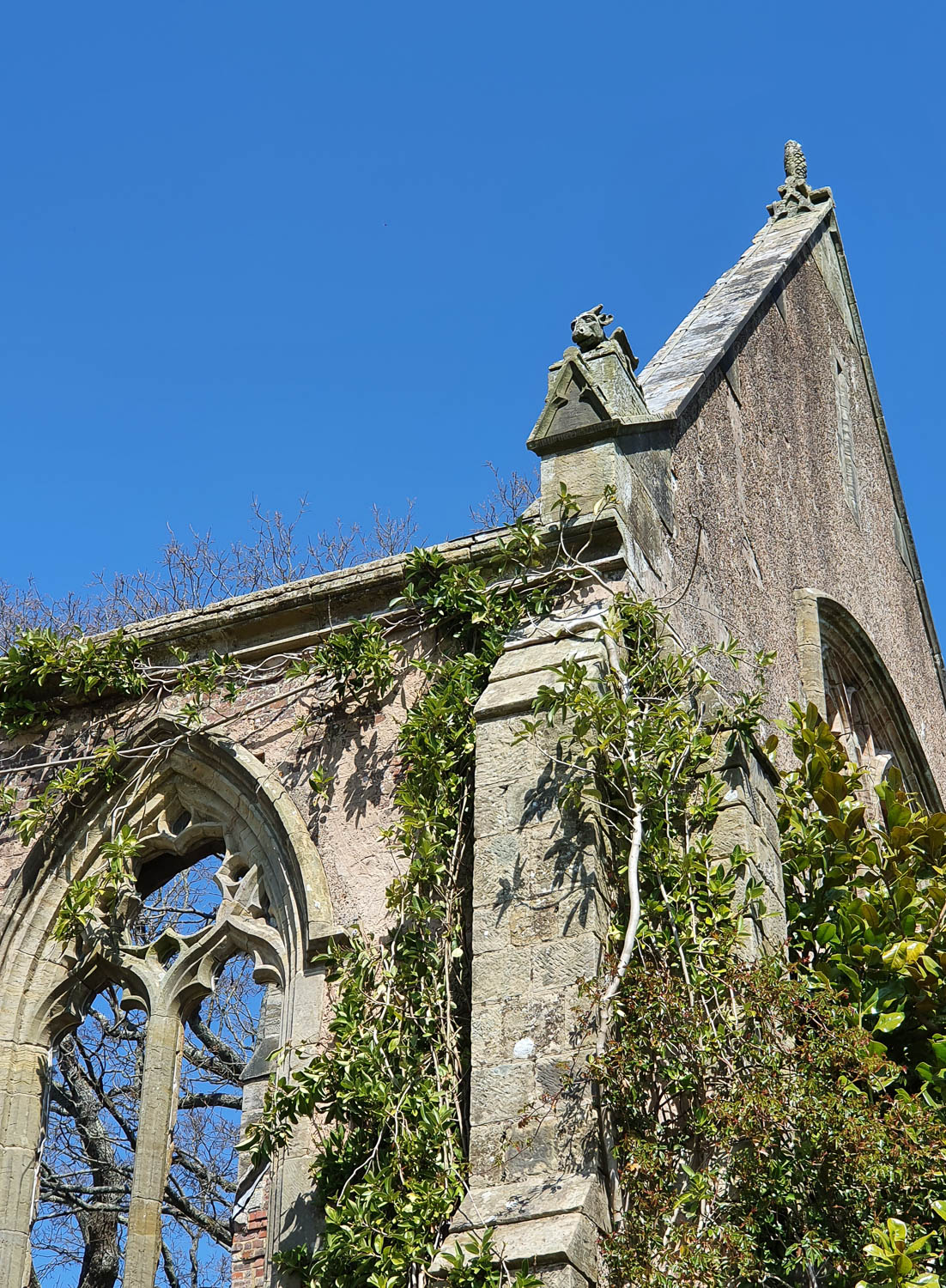View of the side edge of the roof at Nymans showing a small dragon gargoyle on the corner - a visit to Nymans with kids