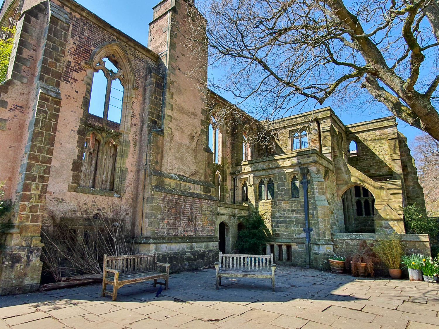 Benches by the arched windows of part of the ruins of the house at Nymans National Trust in Sussex - a day out at Nymans with kids