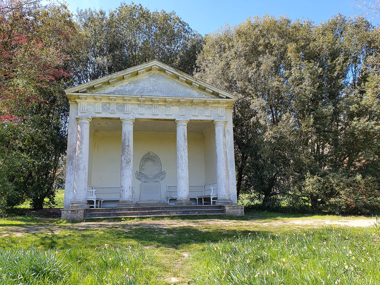 View of the Palladian temple at Petworth surrounded by trees - exploring the gardens and park at Petworth National Trust in Sussex